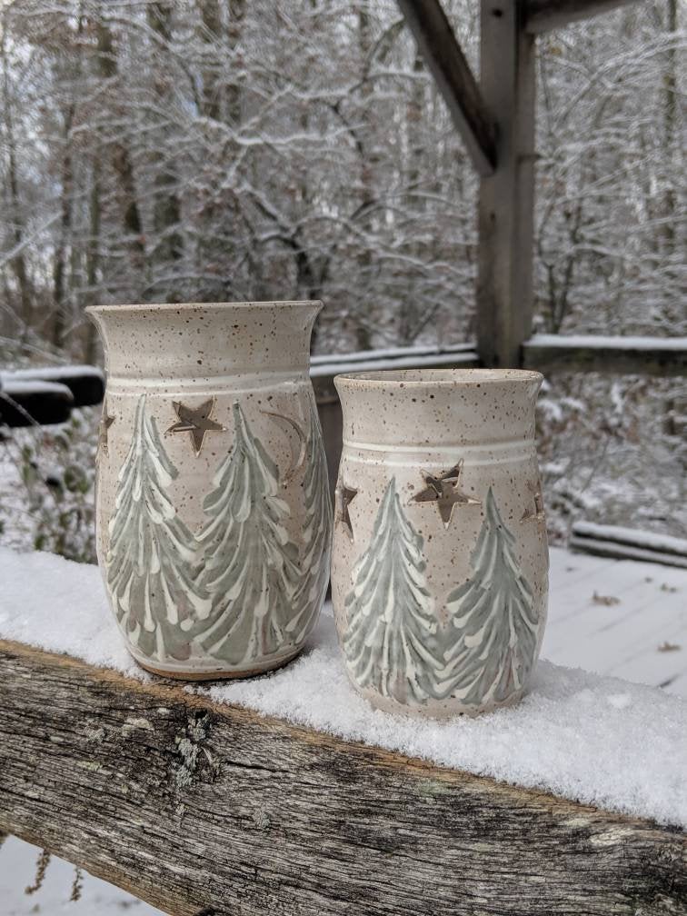 Small votive candle holder with winter trees scene.